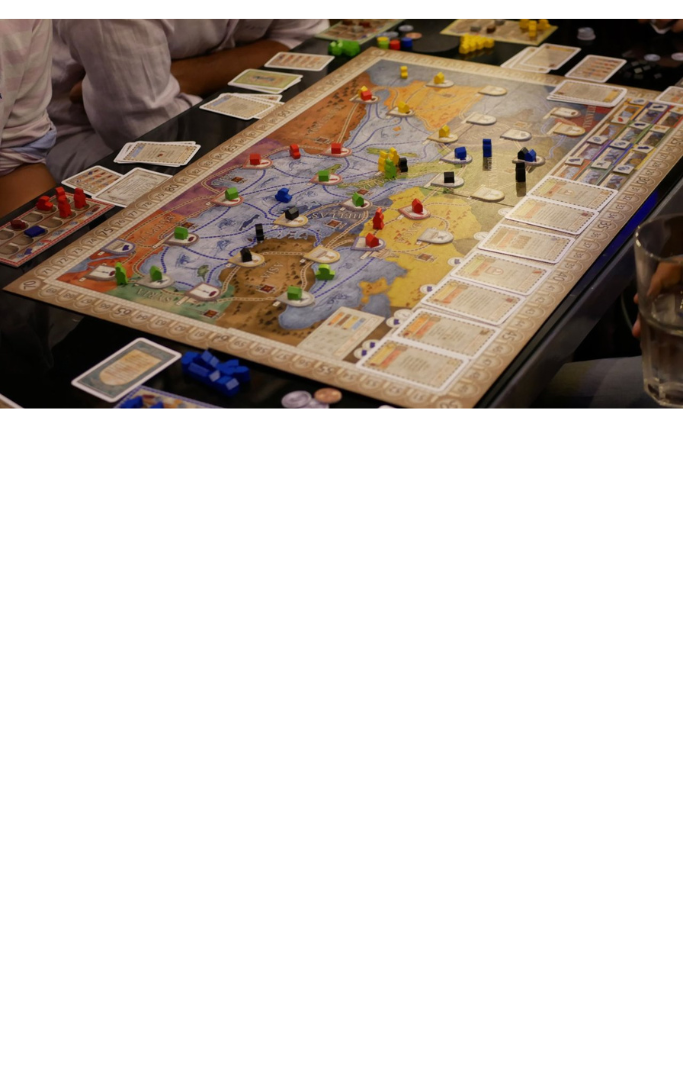 Role playing board game on a table with a group of people around the table